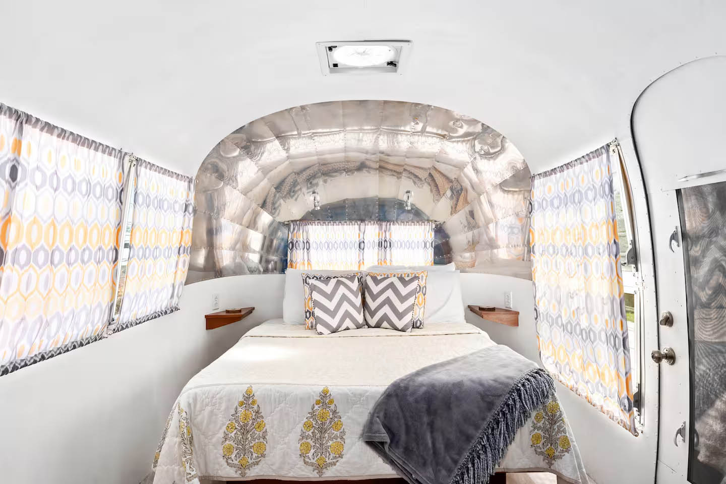 Bedroom interior inside The Zepplin Airstream at Glamp Newport near Newport Rhode Island Bedroom area inside The Zeppelinvintage Airstream rental at Glamp Newport in Portsmouth Rhode Island