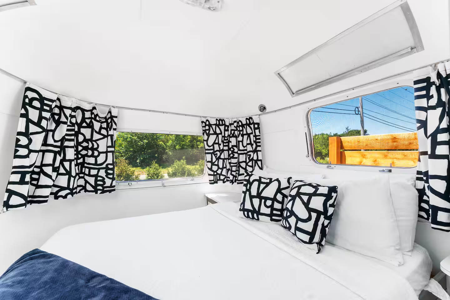 Bedroom interior inside The Joplin Airstream at Glamp Newport near Newport Rhode Island Bedroom interior inside The Joplin vintage Airstream rental at Glamp Newport in Portsmouth Rhode Island