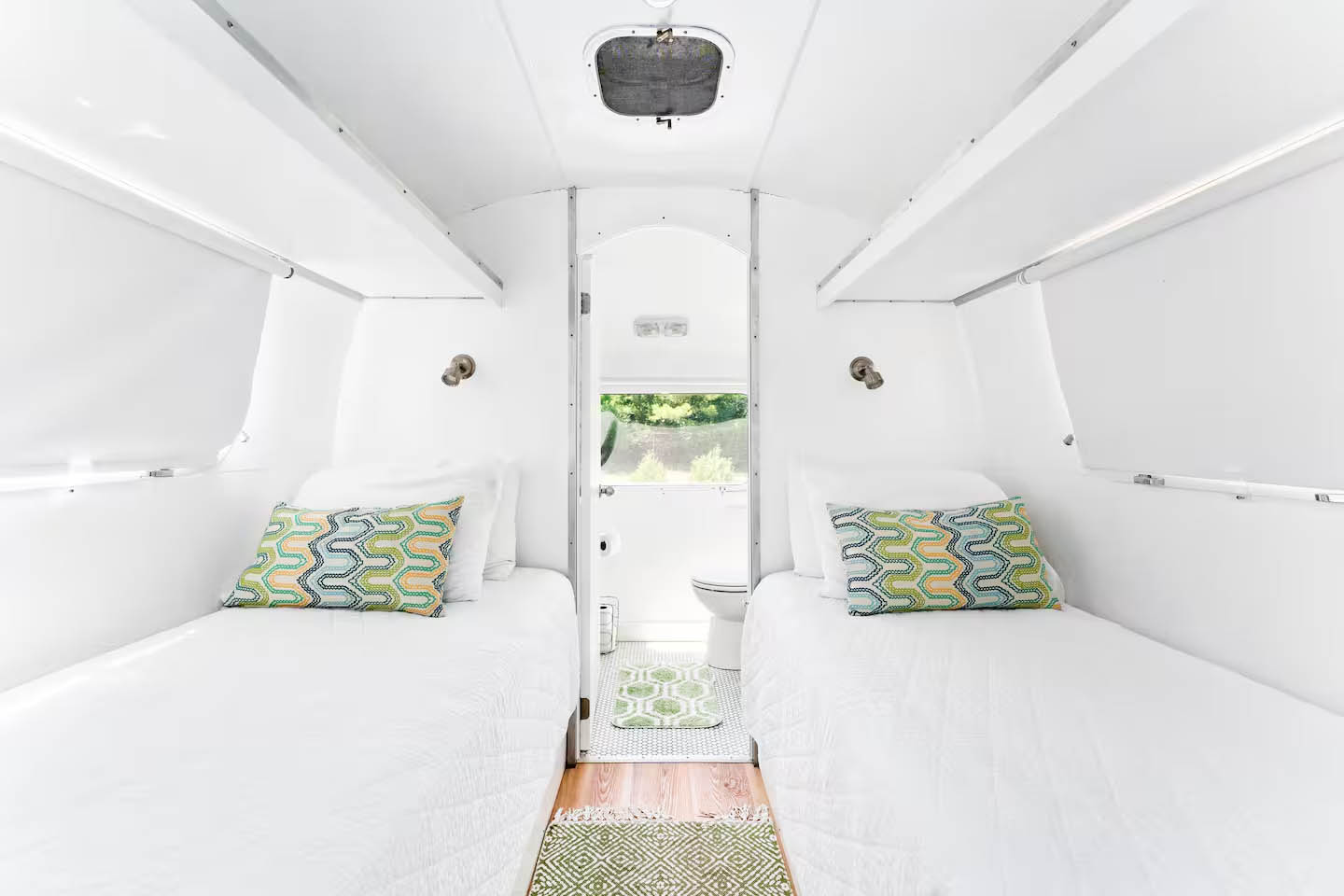 Twin bedroom interior inside The Ellington Airstream at Glamp Newport near Newport Rhode Island Twin bed sleeping area inside The Ellington vintage Airstream rental at Glamp Newport in Portsmouth Rhode Island