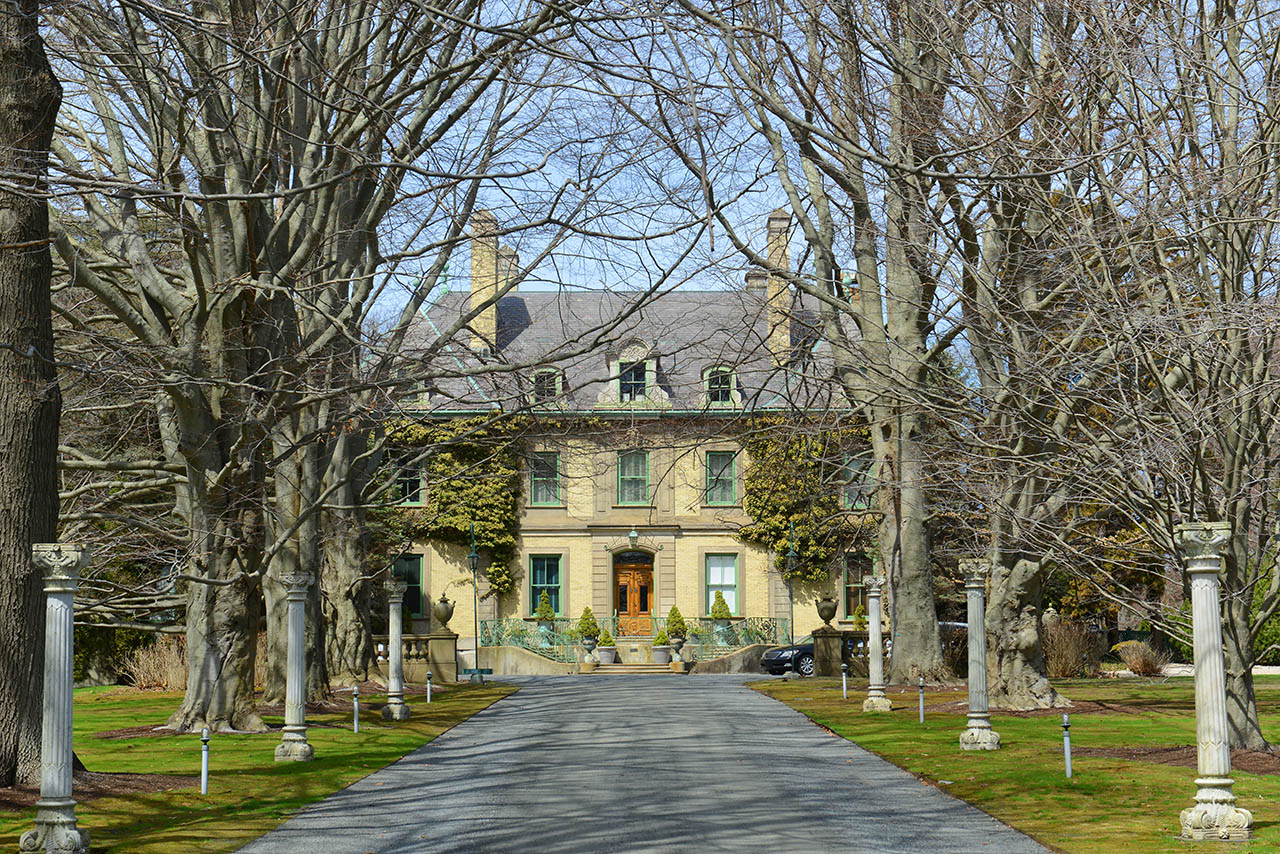 Historic Newport mansion surrounded by trees in Rhode Island