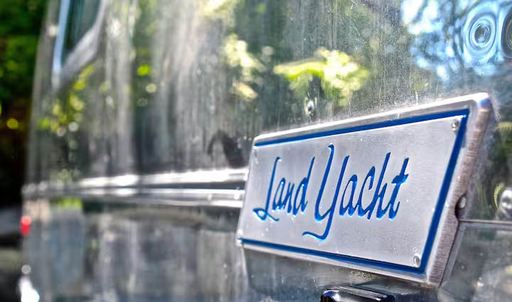 Land Yacht vintage Airstream detail at Glamp Newport near Newport Rhode Island Close-up of the Land Yacht nameplate on a vintage Airstream rental at Glamp Newport in Portsmouth Rhode Island