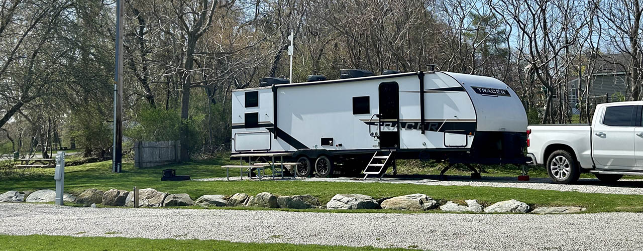 Full hookup RV campsite at Newport RV Park in Portsmouth Rhode Island Travel trailer parked at a full hookup campsite at Newport RV Park in Portsmouth Rhode Island